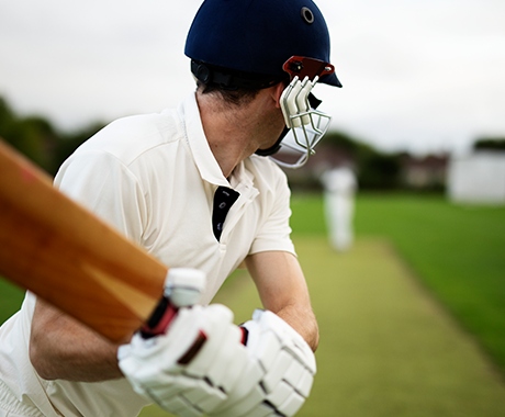 A cricket batter facing a delivery
